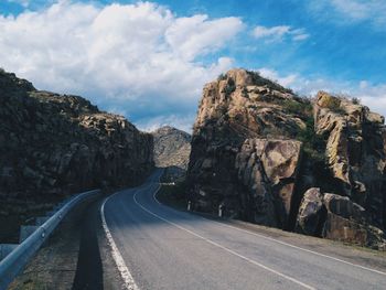 Empty road amidst rocks against sky. altai