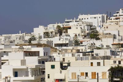 Buildings in city against clear sky