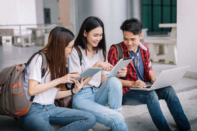 Friends sitting on mobile phone