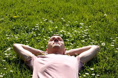 Man lying on grassy field