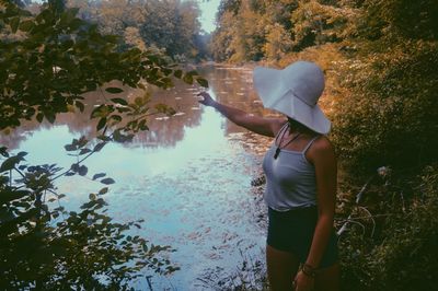 Woman standing at lakeshore