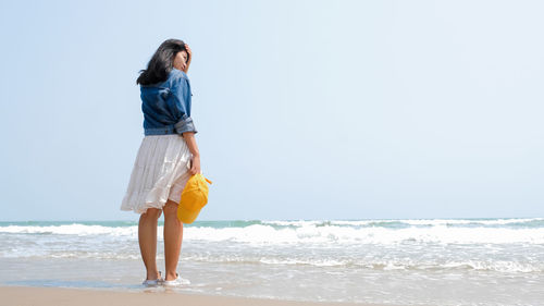 Full length of young woman on beach