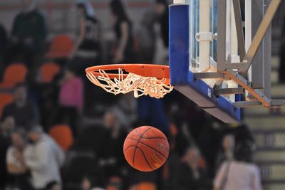 Low angle view of basketball by hoop