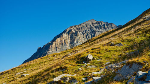 Scenic view of mountains against clear blue sky