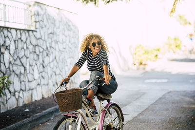 Woman riding bicycle on road