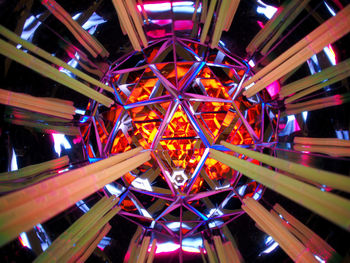 Low angle view of illuminated ferris wheel at night