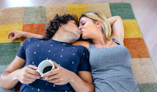 Midsection of couple holding mobile phone