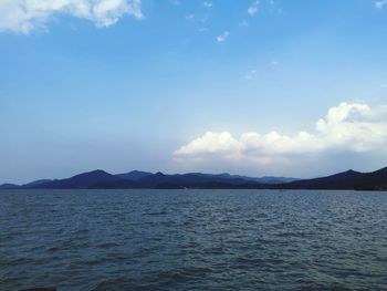 Scenic view of sea and mountains against sky