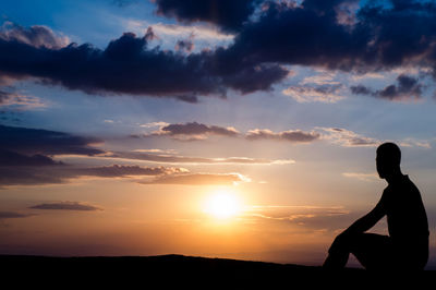 Silhouette people against sky during sunset