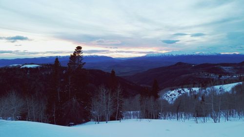 Scenic view of snow covered mountains against sky