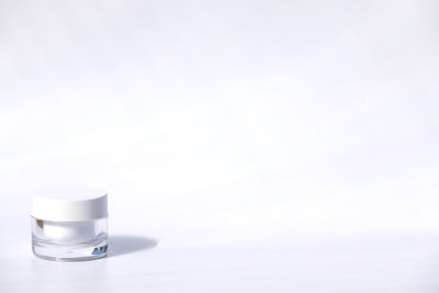 Close-up of coffee cup on table against white background