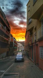 Built structures against sky at sunset