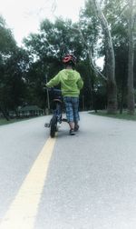 Man riding bicycle on road