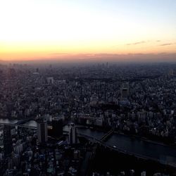 Aerial view of cityscape against sky during sunset