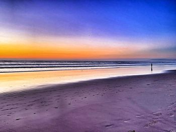 Scenic view of beach against sky during sunset