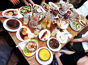 High angle view of people preparing food on table