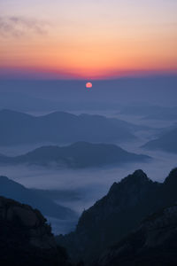 Scenic view of silhouette mountains against sky during sunset