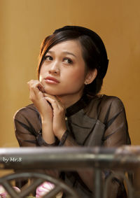 Portrait of young woman sitting outdoors