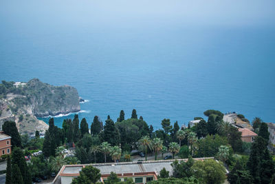 High angle view of buildings and sea against sky