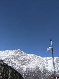 Snowcapped mountains against clear blue sky