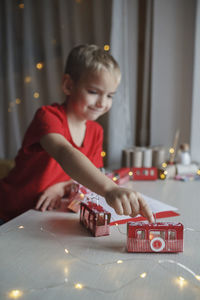 Boy playing with toy blocks at home