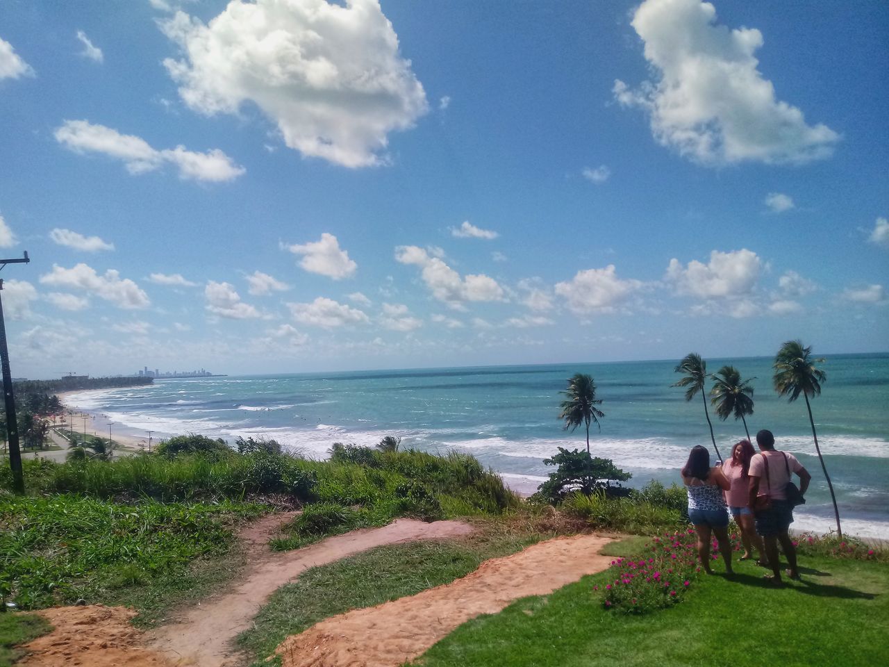 REAR VIEW OF PEOPLE ON BEACH