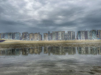 Cityscape against cloudy sky