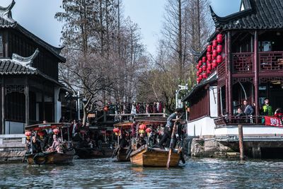 People in boat against building