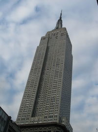 Low angle view of building against cloudy sky