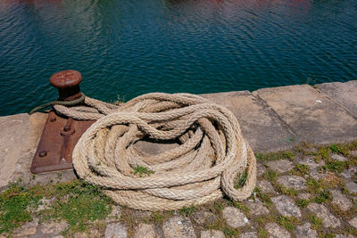 High angle view of rope tied on wooden post