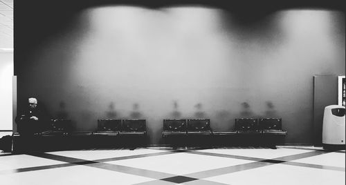 Empty chairs and table against wall at home