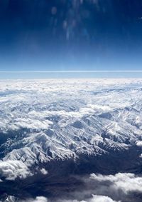 High angle view of snowcapped mountain against sky