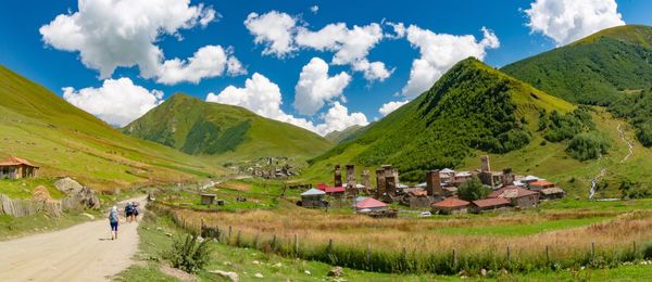 Panoramic view of agricultural field and mountains against sky