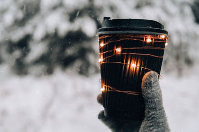 Low section of person holding snow