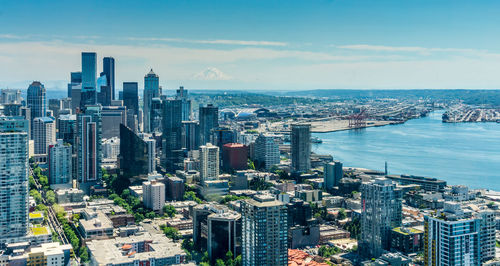 Buildings in downtown seattle with mount rainier in the distance.