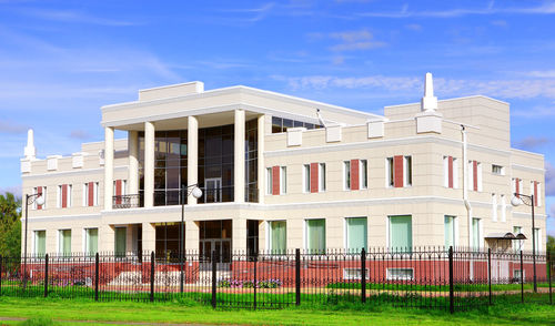 Built structure by building against blue sky