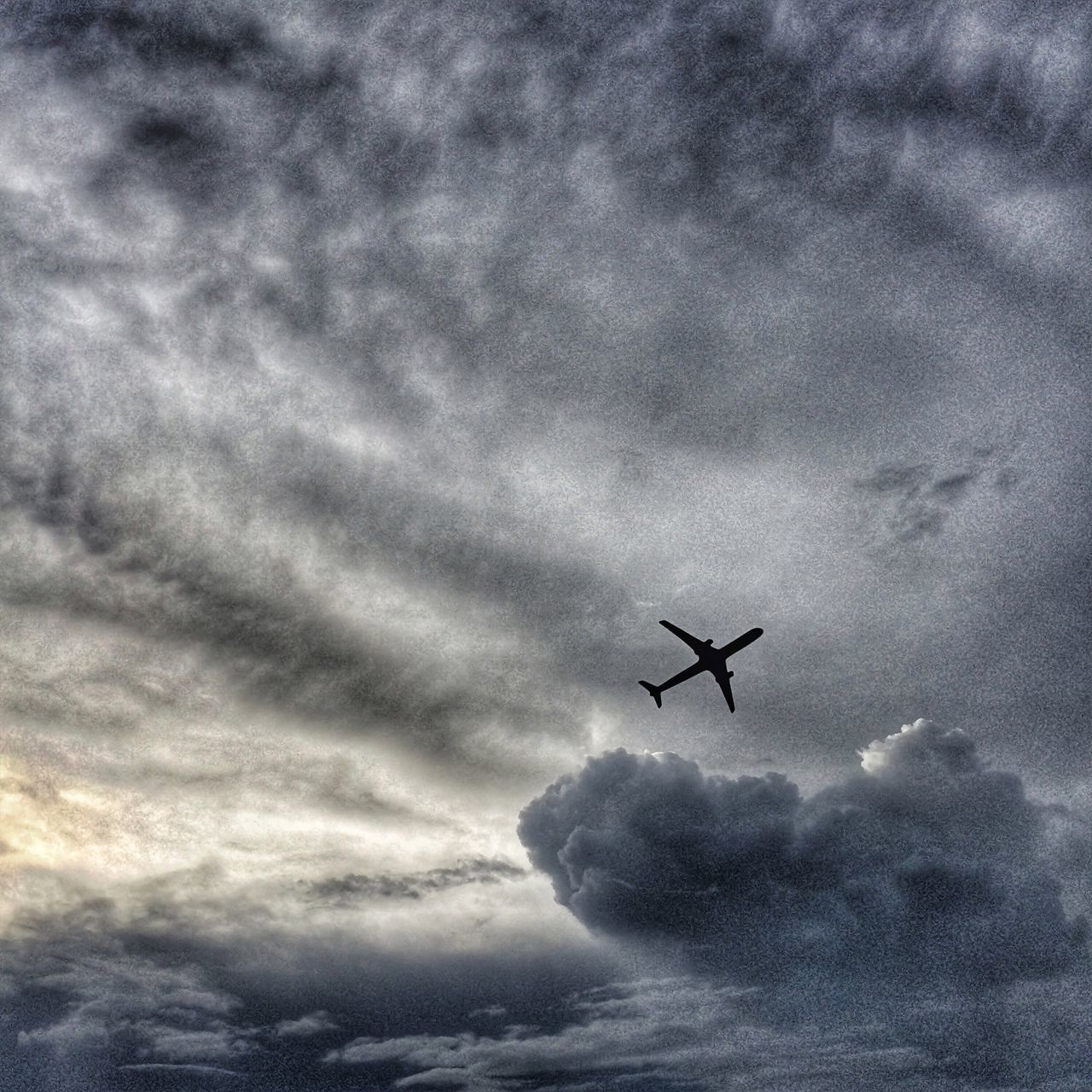 transportation, airplane, mode of transport, flying, air vehicle, sky, cloud - sky, mid-air, low angle view, cloudy, on the move, travel, silhouette, journey, weather, motion, cloud, nature, overcast, speed