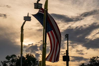 Low angle view of flag against sky during sunset