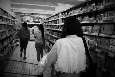 Rear view of woman standing in store