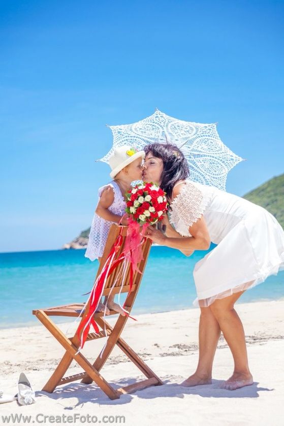 sea, beach, clear sky, lifestyles, leisure activity, water, blue, sand, casual clothing, sunlight, young adult, full length, vacations, shore, copy space, horizon over water, person, young women