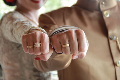 Close-up of couple holding hands