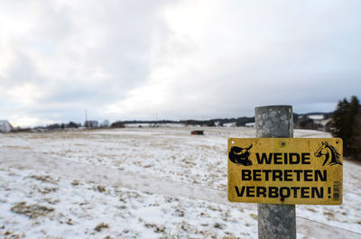 Information sign on snow covered land