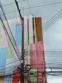 Low angle view of buildings and wires 