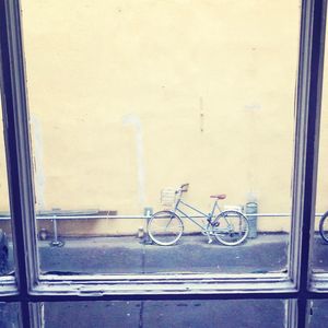 Bicycle parked against wall