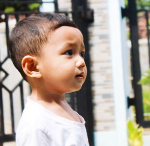Close-up portrait of cute boy looking away