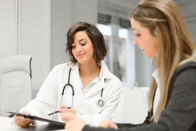 Female doctor discussing with patient at hospital