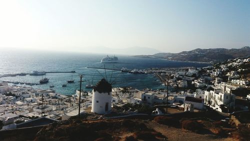 High angle view of townscape by sea against sky