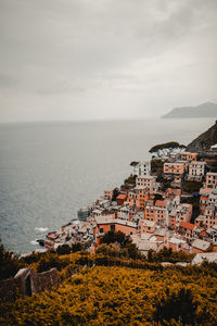 Townscape by sea against sky