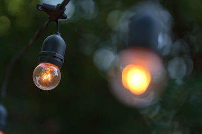 Low angle view of illuminated light bulb