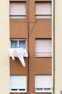 Low angle view of clothes drying against building